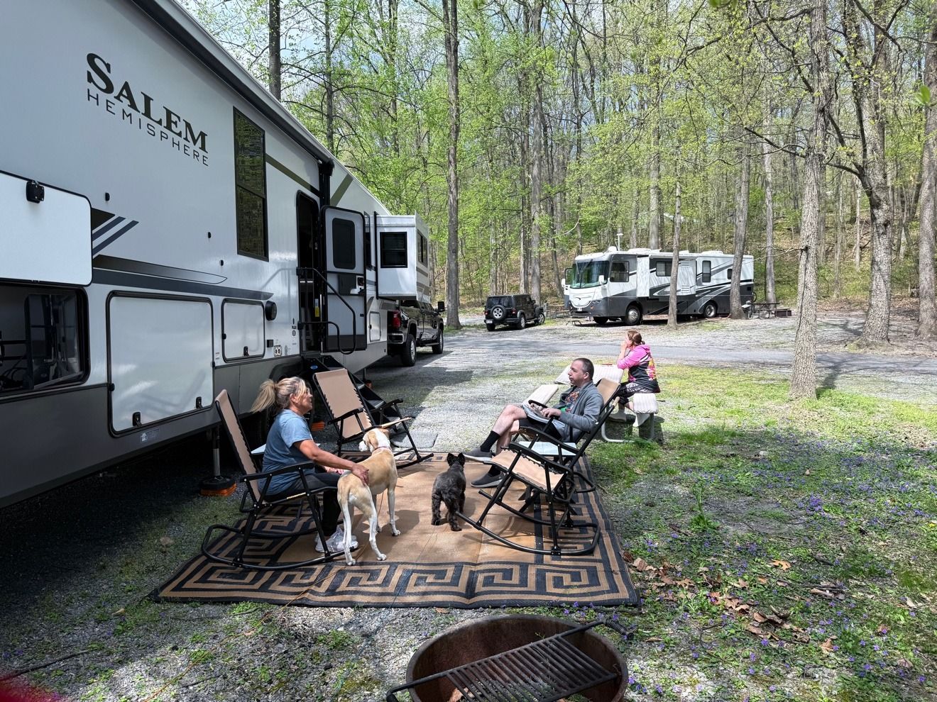 Chairs and our dogs settled at a campsite beside the rig