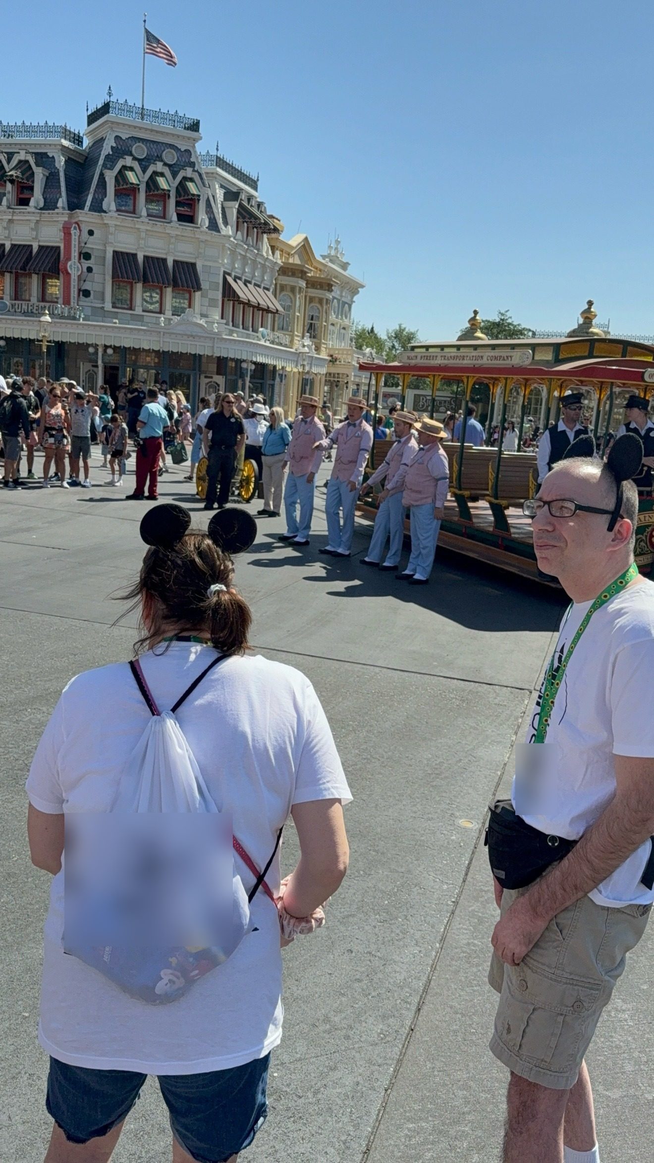 Wearing a green sunflower lanyard on Main Street at a Disney park