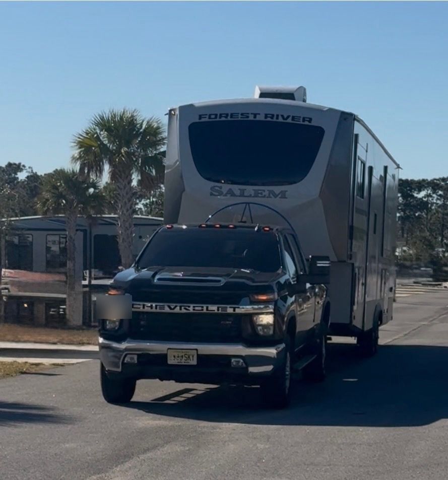 Towing the fifth wheel down a palm-lined road